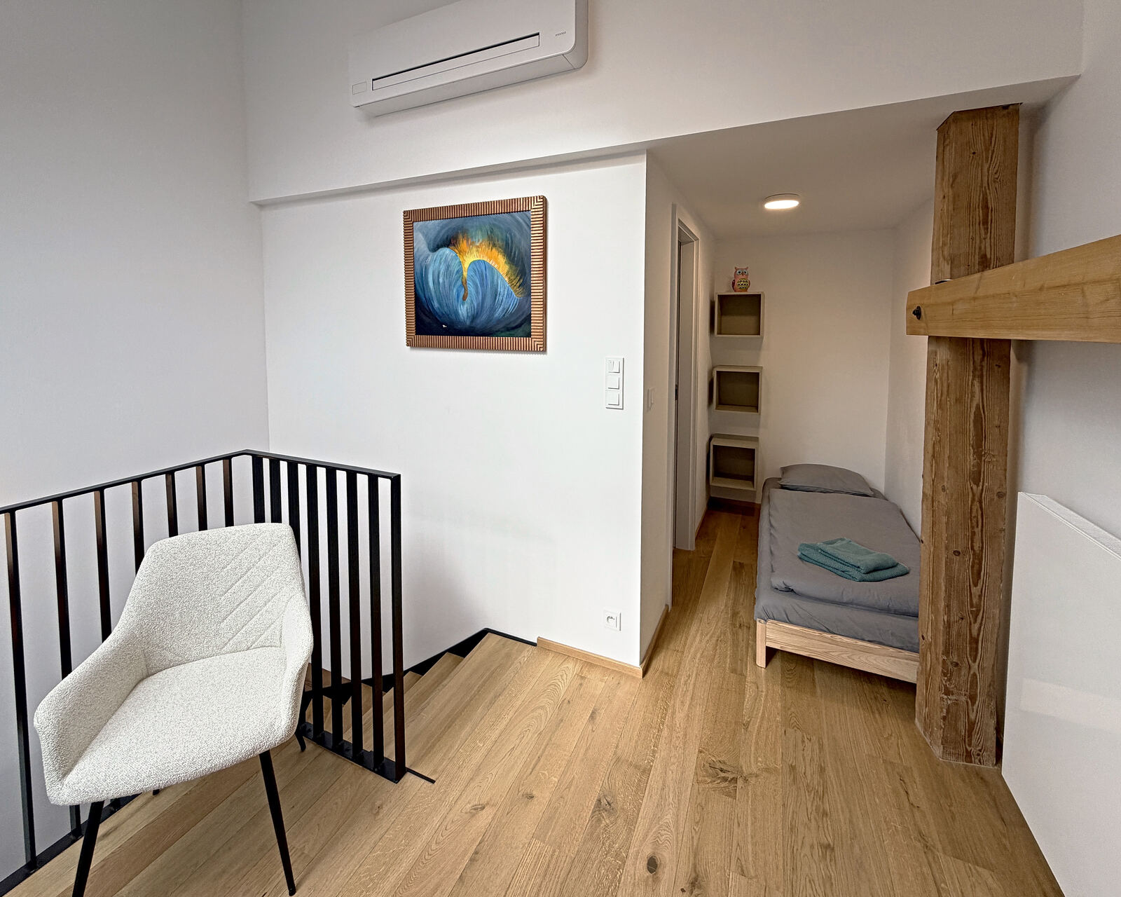 Gallery with armchair and a separate single bed