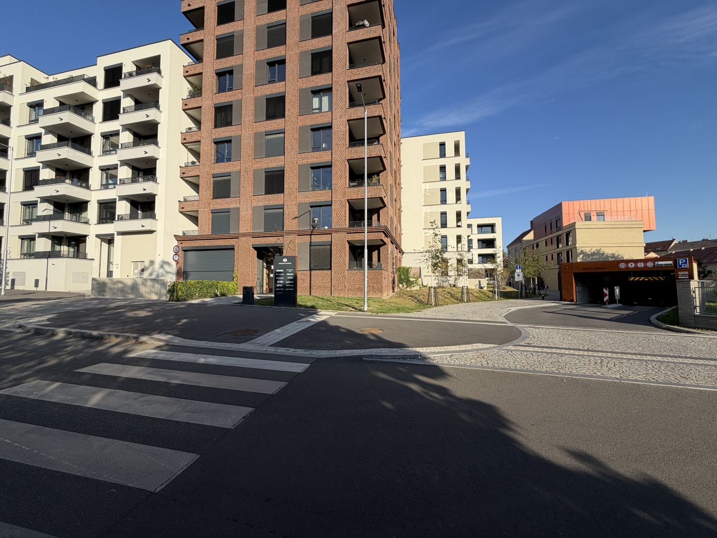 Go back to your car. The garage entrance is on Závišova street – the door in the