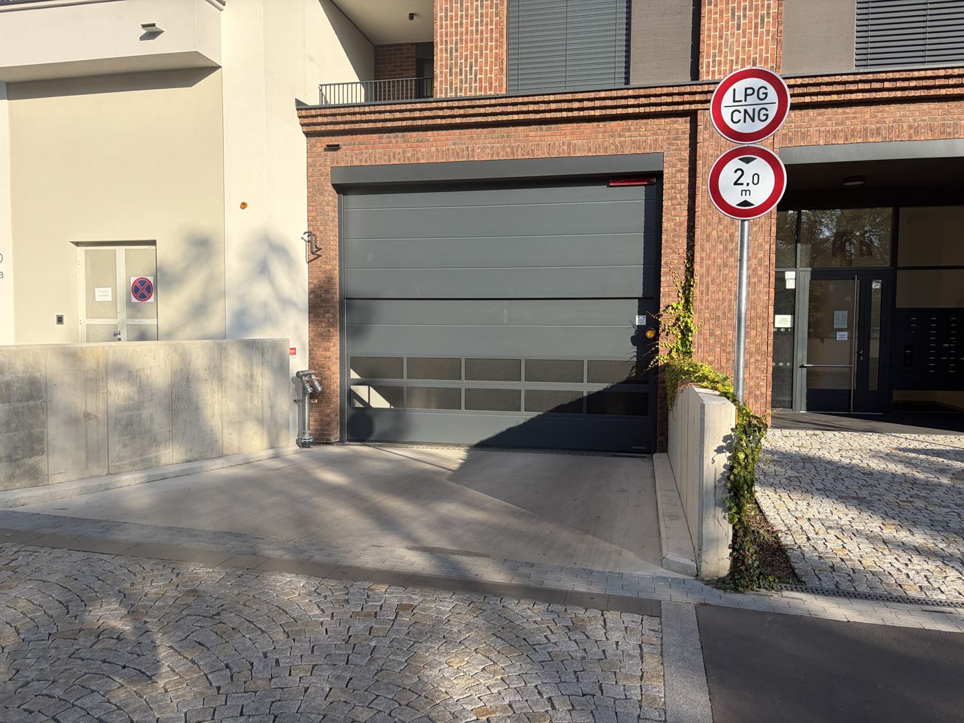 Go back to your car. The garage entrance is on Závišova street – the door in the