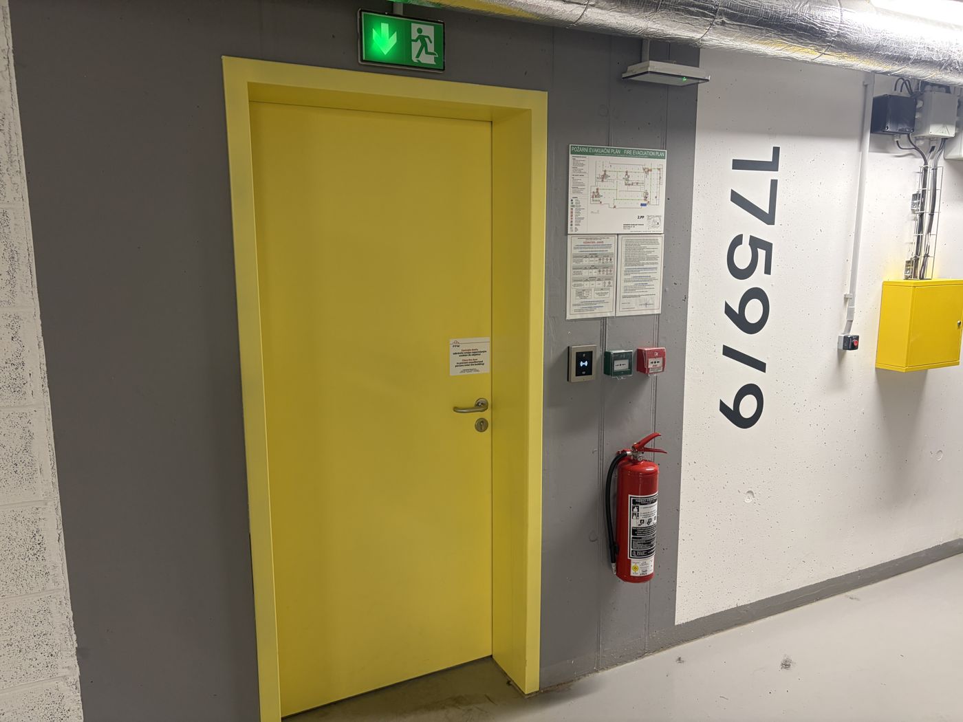Pedestrian exit: with your back to the car, walk left to the yellow door marked 