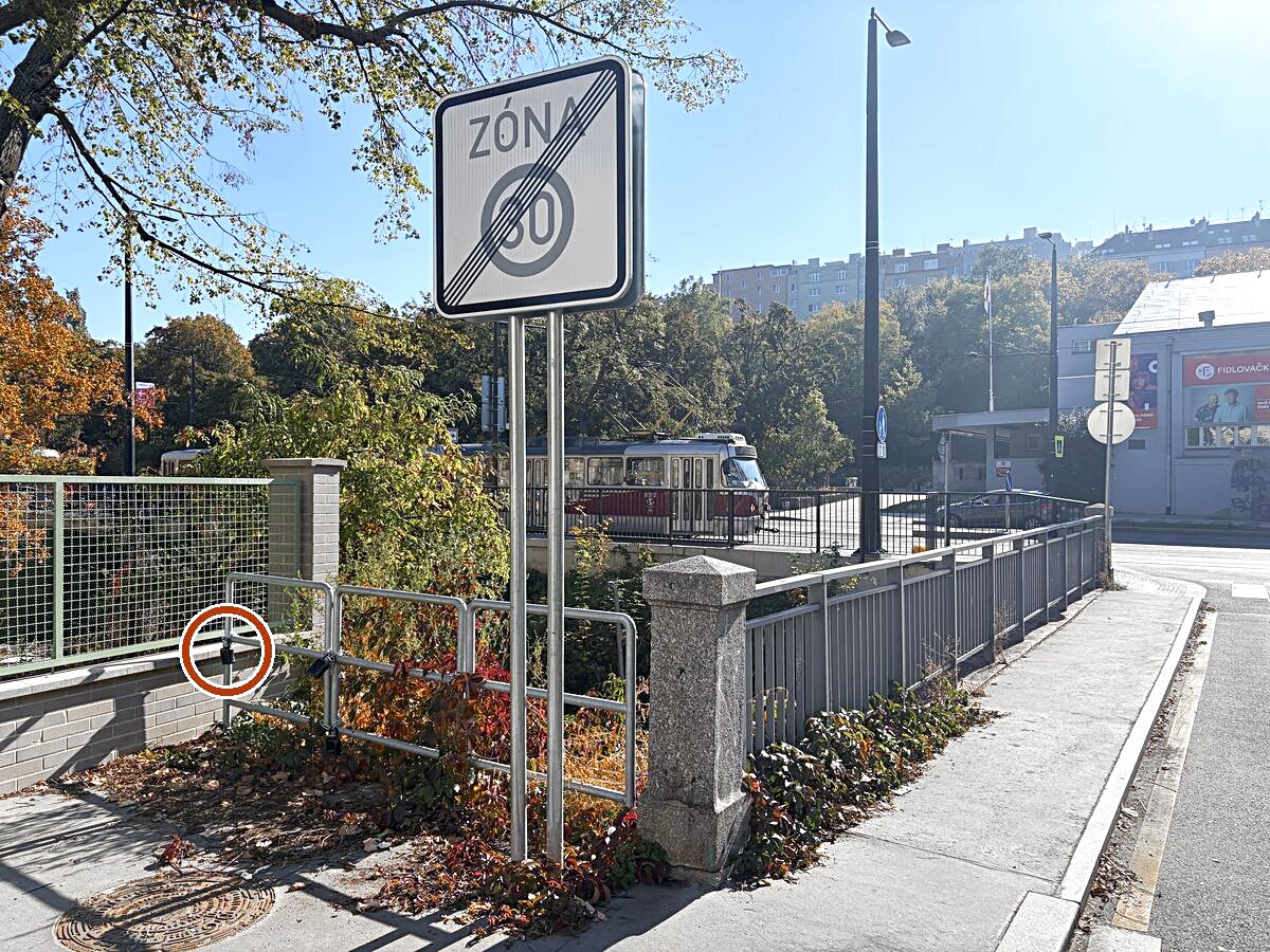 Right after the bridge, on your right in the corner by the green fence, there is