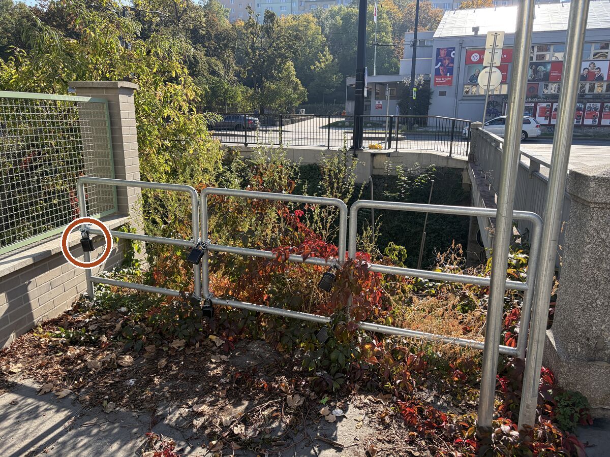 Right after the bridge, on your right in the corner by the green fence, there is